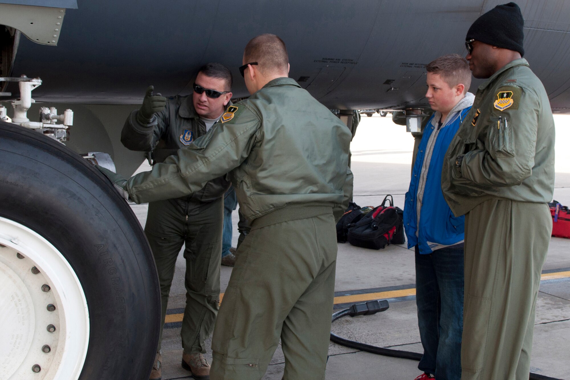 U.S. Air Force Lt. Col. Jimmy Jackson shows pre-flight inspection points on the landing gear for the B-52 Stratofortress on Jan. 30, 2015, Barksdale Air Force Base, La.  Students received a briefing of the B-52 as part of a job shadow day to see what it is like to be a pilot. (U.S. Air Force photo by Master Sgt. Dachelle Melville/Released)