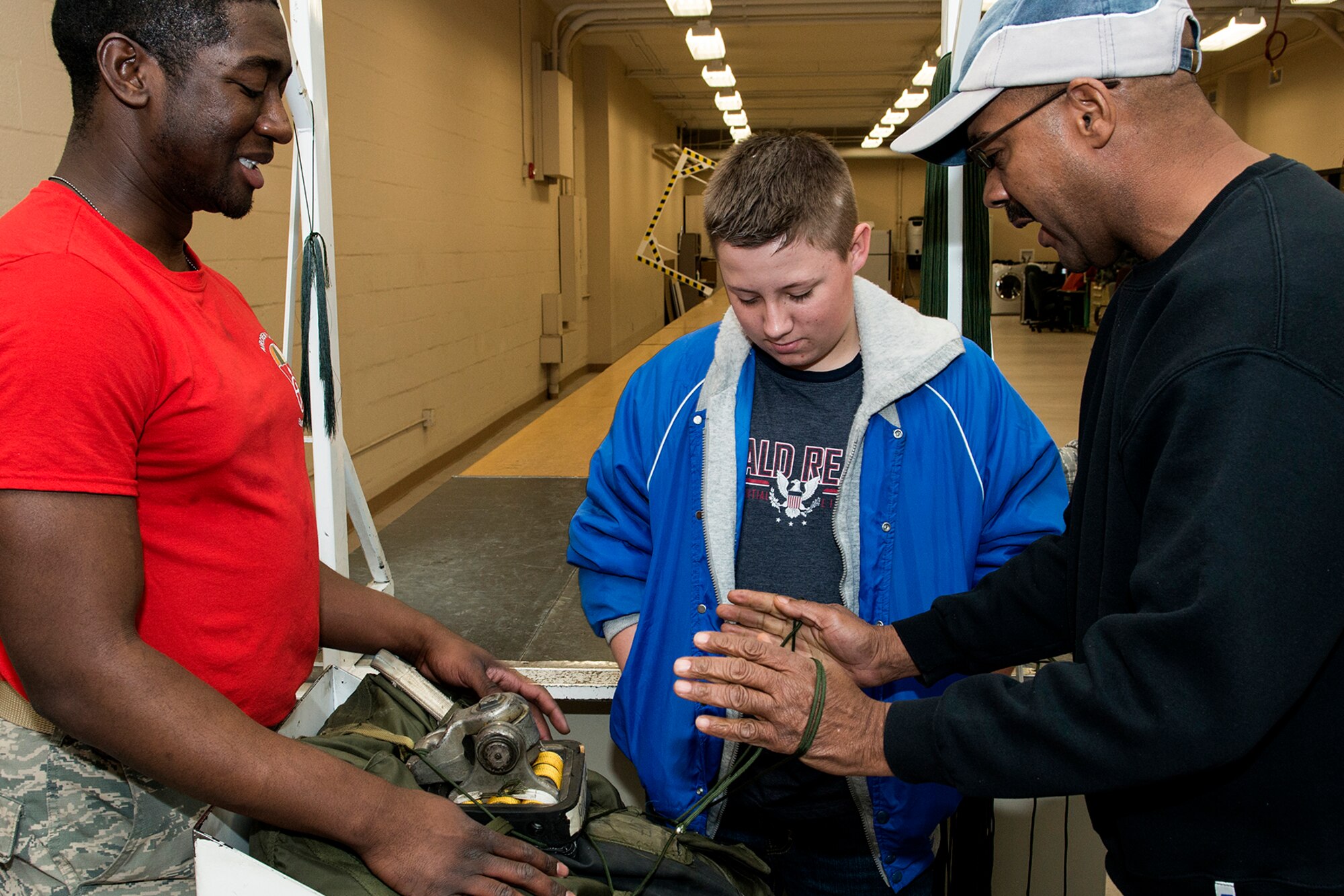 A Greenacres Middle School student helps repack a B-52H Stratofortress drag chute during a tour of the 307th Operations Support Squadron parachute shop on Jan. 30, 2015, Barksdale Air Force Base, La. The student, who wants to be an Air Force pilot, participated in a "Shadow Day" and got a tour of the Air Force Reserve Command's 307th Bomb Wing. (U.S. Air Force photo by Master Sgt. Greg Steele/Released)