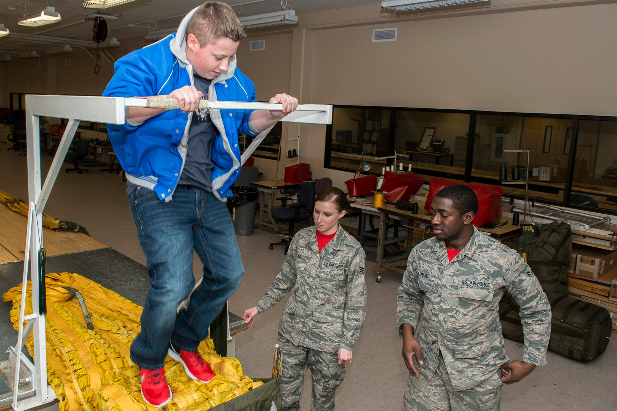 A Greenacres Middle School student helps repack a B-52H Stratofortress drag chute during a tour on Jan. 30, 2015, Barksdale Air Force Base, La. The student, who wants to be an Air Force pilot, participated in a "Shadow Day" hosted by the Air Force Reserve Command's 307th Bomb Wing. (U.S. Air Force photo by Master Sgt. Greg Steele/Released)
