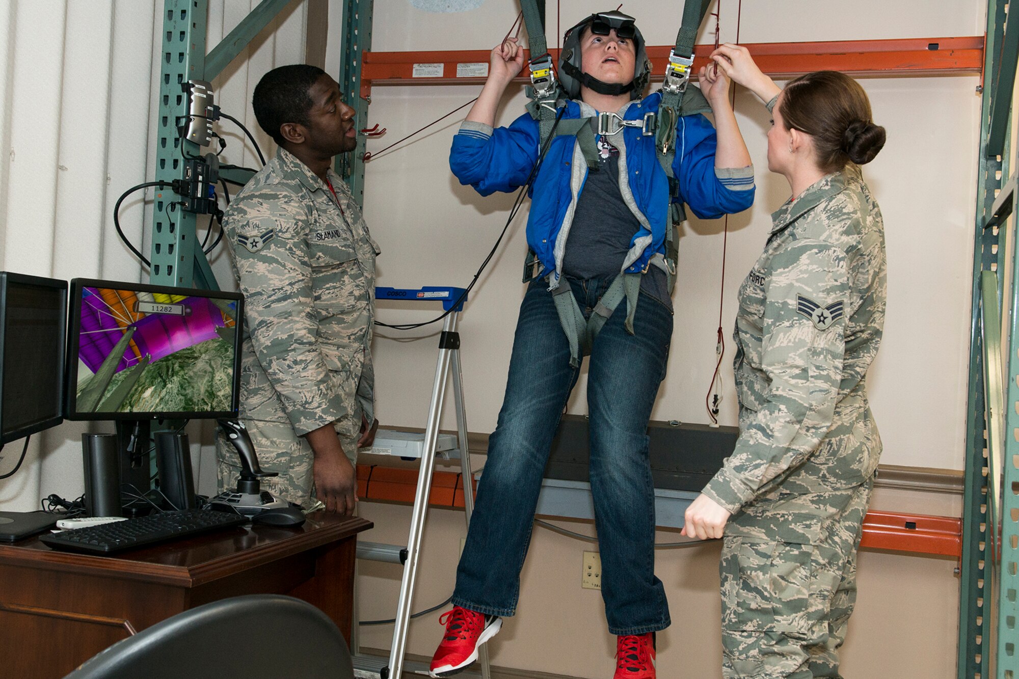 A Greenacres Middle School student hangs from the virtual parachute trainer during a tour on Jan. 30, 2015, Barksdale Air Force Base, La. The student, who wants to be an Air Force pilot, participated in a "Shadow Day" and got a tour of the Air Force Reserve Command's 307th Bomb Wing to experience a day in the life of a B-52 pilot. (U.S. Air Force photo by Master Sgt. Greg Steele/Released)