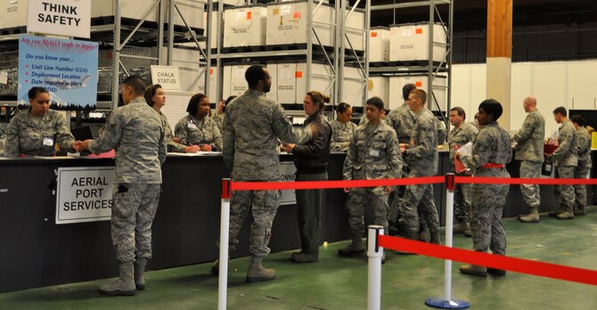Reservists from the 446th Airlift Wing progress though a deployment processing line at the logistics readiness warehouse Feb. 7, 2015. A total of 189 Reservists were tasked for a mock deployment as part of EXERCISE SNAPSHOT, a joint training venture between Team McChord’s 446th AW, 627th Air Base Group and 62nd Airlift Wing. The training event also included a patient on-load demonstration and air evacuation. (U.S. Air Force Reserve photo by Master Sgt. Minnette Mason)