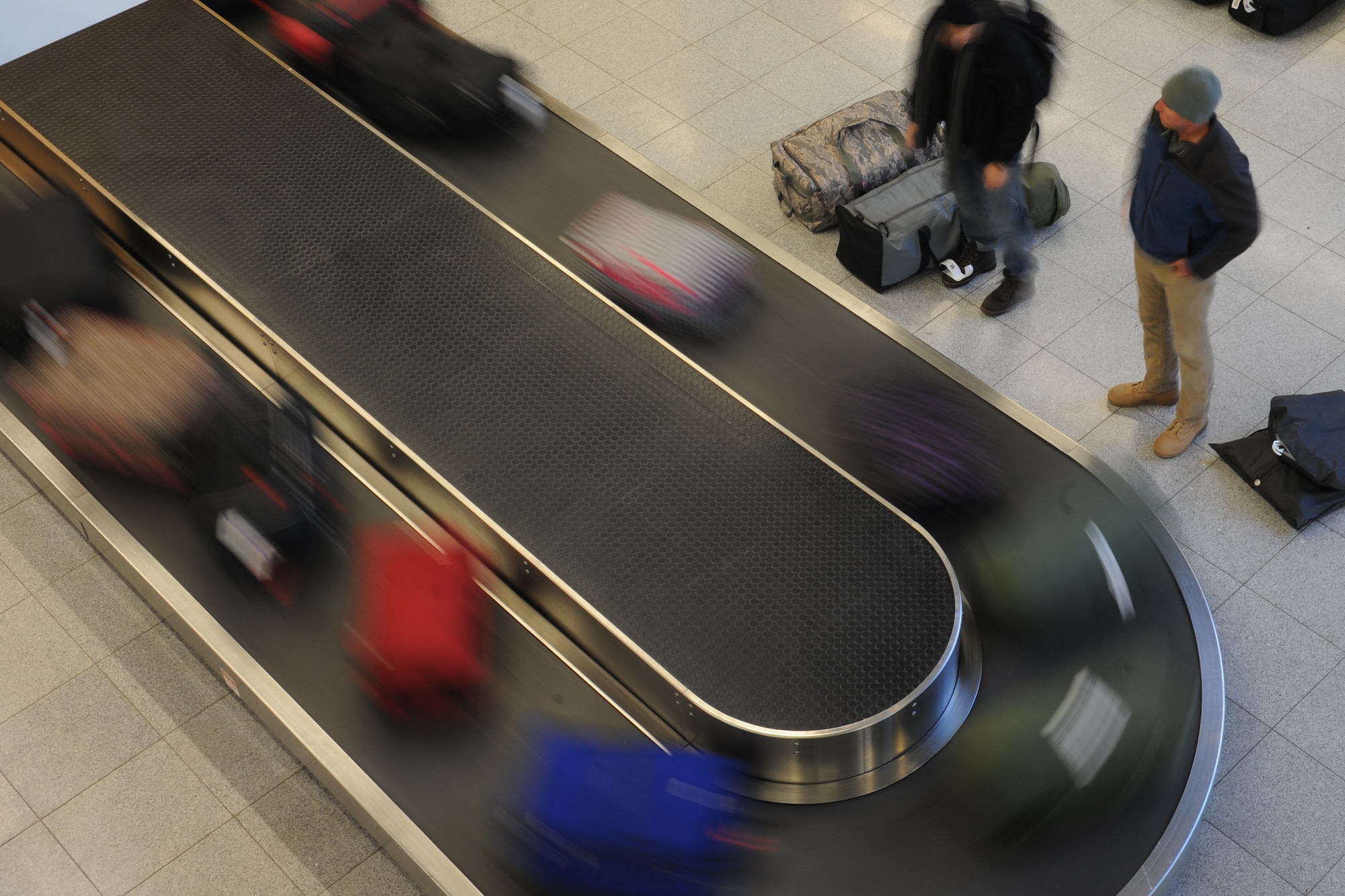 Passengers wait for luggage at the passenger terminal on Ramstein Air Base, Germany, Feb. 4, 2015. The passenger terminal serves thousands of service members a month, sending them to deployed locations, seeing their loved ones, or bringing them home. (U.S. Air Force Photo/Airman 1st Class Michael Stuart) 