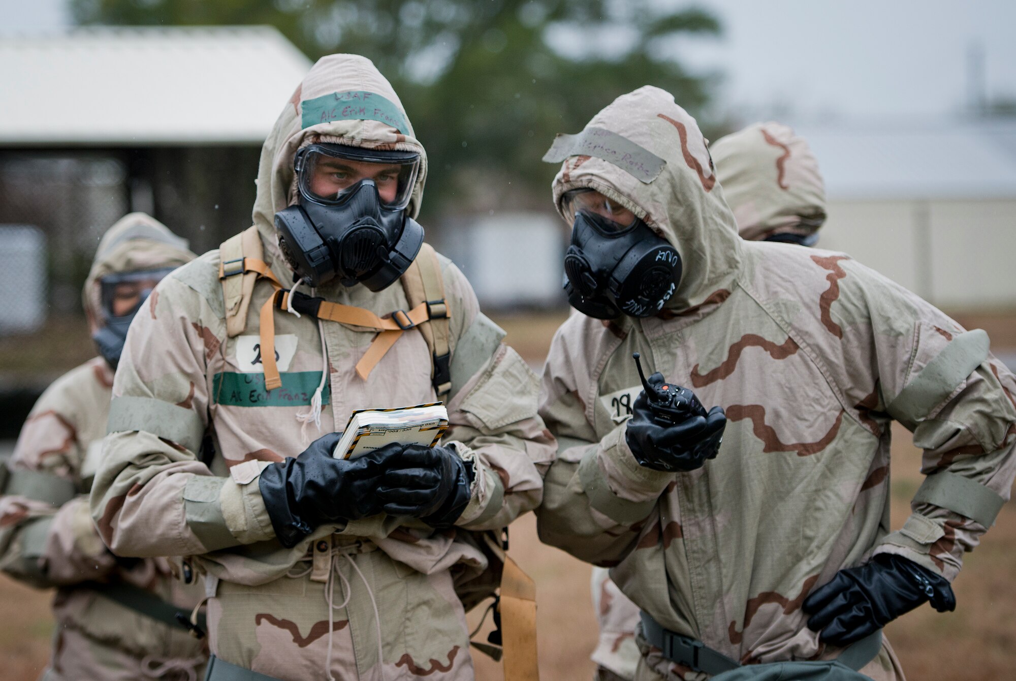 An Airman reviews his training manual during a rainy Phase II readiness exercise Feb. 4 at Eglin Air Force Base, Fla.  A Phase II evaluates an Airman’s ability to meet wartime and contingency taskings of employing and sustaining the force and the ability to survive and operate. More than 30 potential deployers received classroom and practical field training during the exercise. (U.S. Air Force photo/Samuel King Jr.)