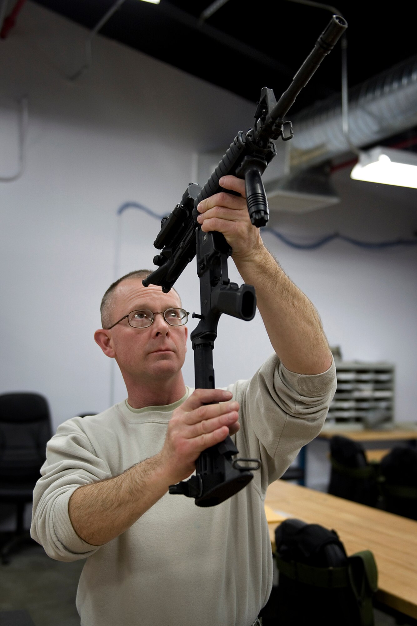 Master Sgt. Chet Nance, 434th Security Forces Squadron combat arms noncommissioned officer in charge, inspects an M-4 rifle at Grissom Air Reserve Base, Ind., Jan. 28, 2014. Grissom's combat arms instructors are responsible for inspections and repairs of approximately 1,600 weapons. (U.S. Air Force photo/Tech. Sgt. Benjamin Mota)