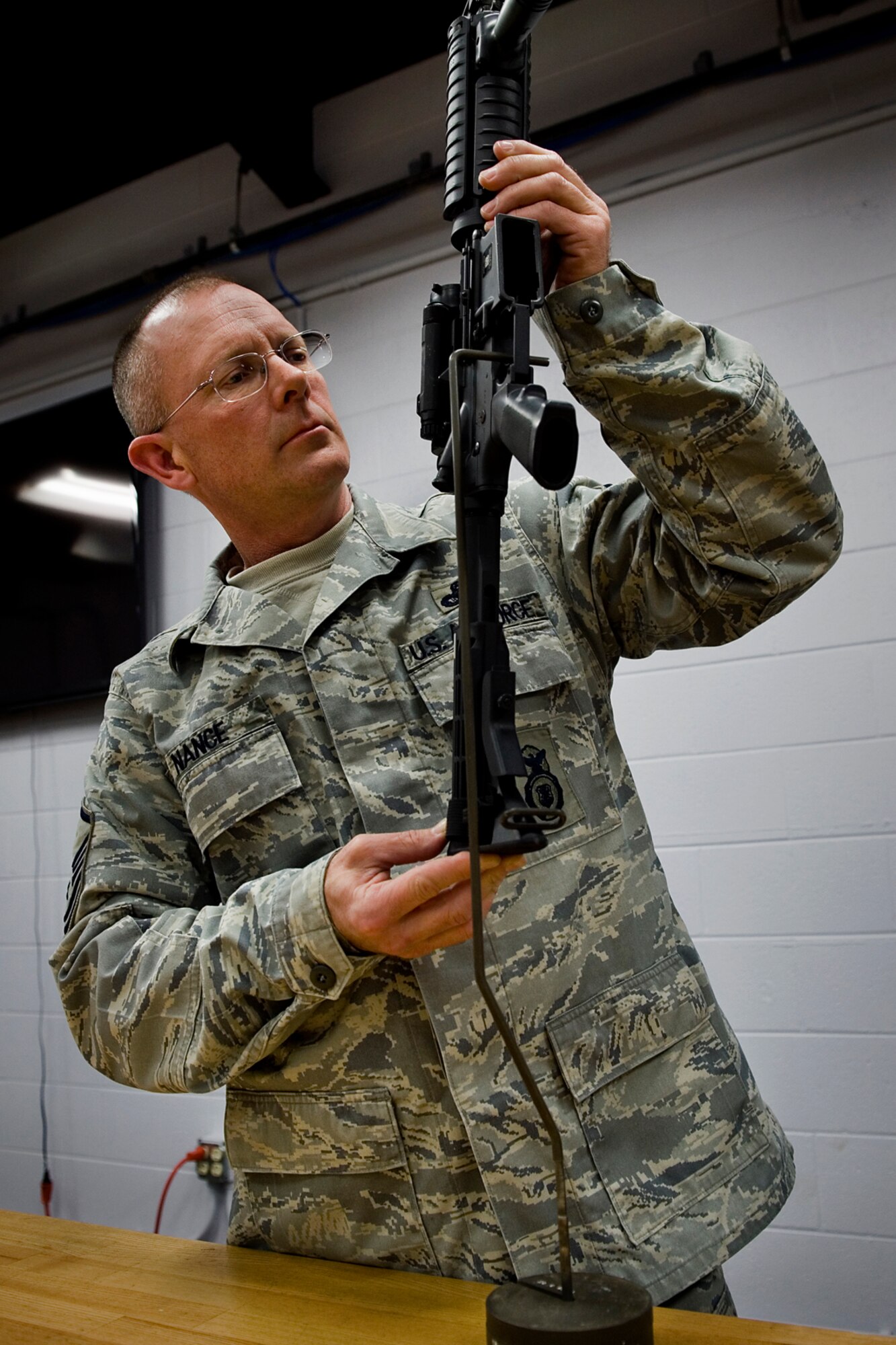 Master Sgt. Chet Nance, 434th Security Forces Squadron combat arms noncommissioned officer in charge, checks an M-4 rifle's trigger-pull to ensure it falls under the measurements outlined in technical orders at Grissom Air Reserve Base, Ind., Jan. 28, 2014. Grissom's combat arms instructors are responsible for inspections and repairs of approximately 1,600 weapons. (U.S. Air Force photo/Tech. Sgt. Benjamin Mota)