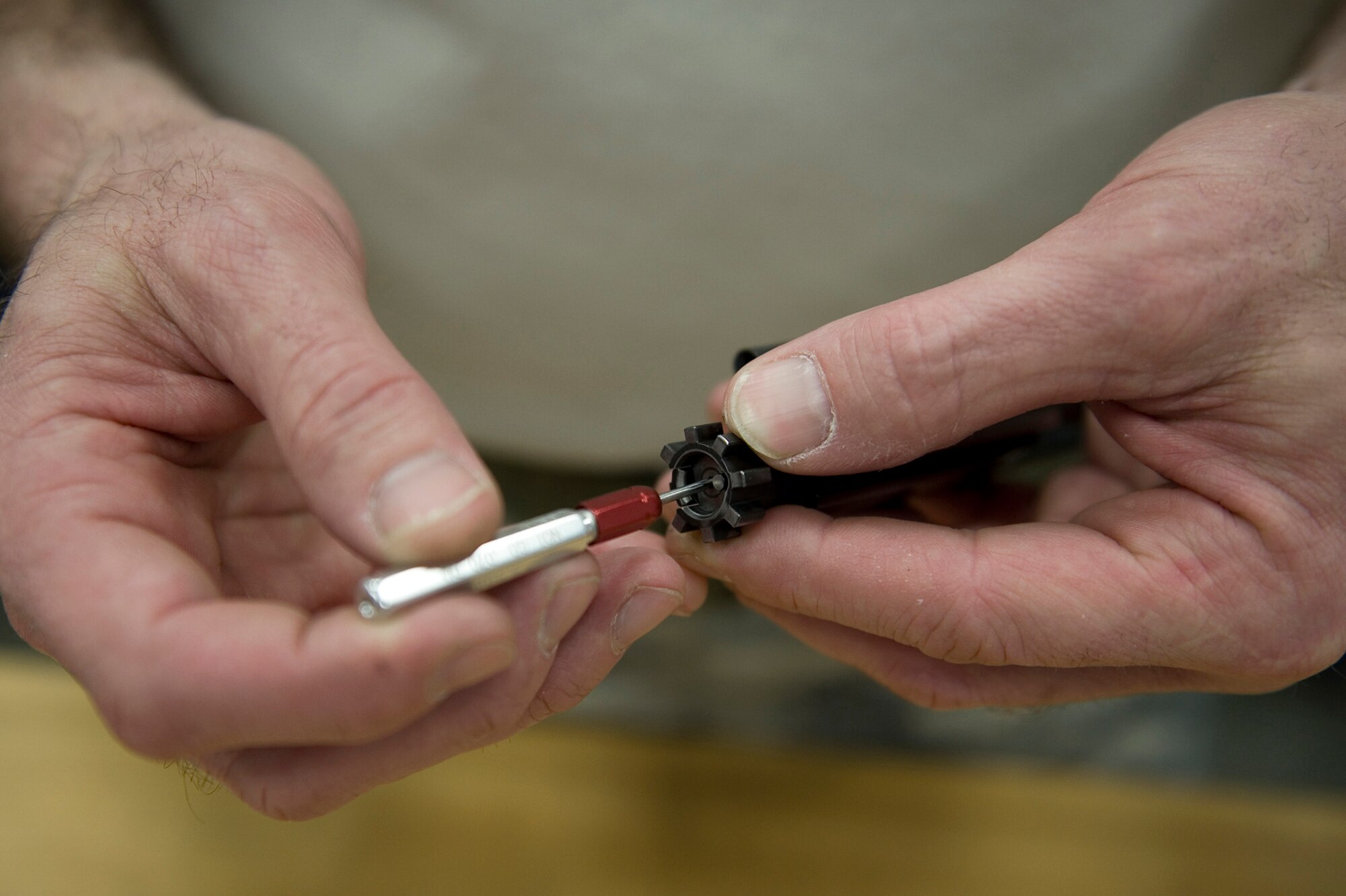 Master Sgt. Chet Nance, 434th Security Forces Squadron combat arms noncommissioned officer in charge, measures the firing pin of an M-4 rifle at Grissom Air Reserve Base, Ind., Jan. 28, 2014. Grissom's combat arms instructors conduct inspections and repairs on eight weapons systems to ensure all Grissom's 1,600 weapons remain mission ready. (U.S. Air Force photo/Tech. Sgt. Benjamin Mota)