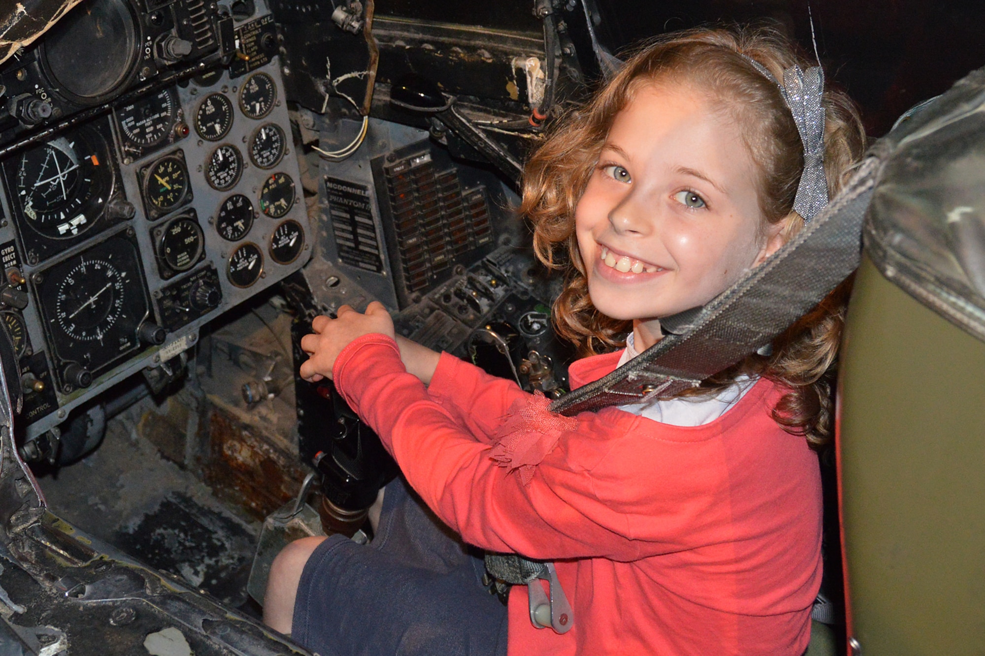 DAYTON, Ohio - A museum visitor enjoying the F-4D Phantom II Sit-in Cockpit in the Cold War Gallery at the National Museum of the U.S. Air Force. (U.S. Air Force photo)