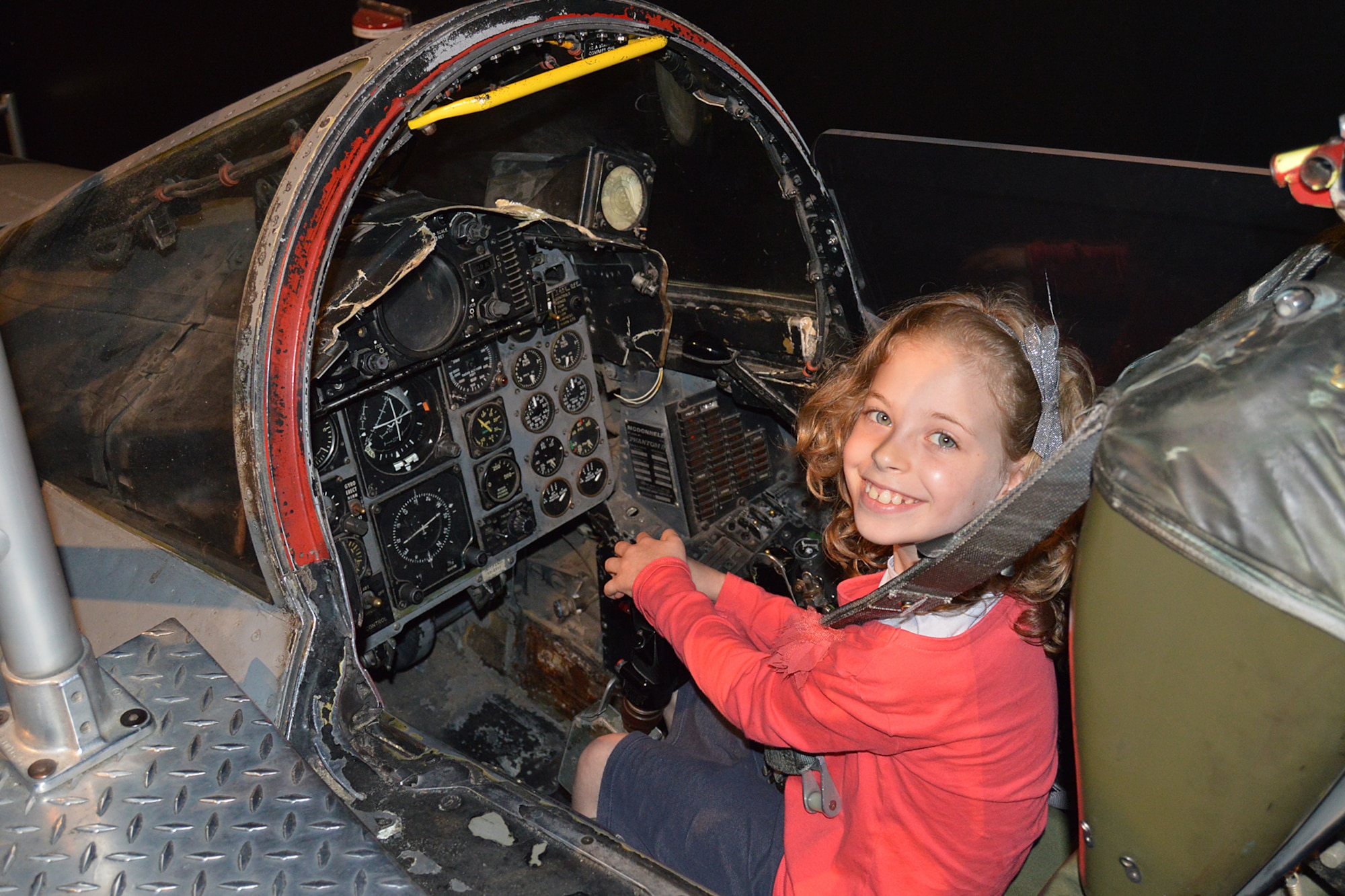 A museum visitor enjoying the F-4D Phantom II Sit-in Cockpit in the Cold War Gallery at the National Museum of the U.S. Air Force. (U.S. Air Force photo)