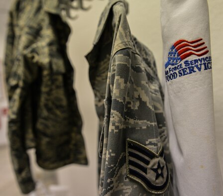 An apron hangs next to an Airman Battle Uniform at the Rheinland Inn Dining Facility, Ramstein Air Base, Germany, Feb. 4, 2015. The DFAC food service team provides healthy options to help ensure Airmen meet Air Force fitness standards. (U.S. Air Force photo/Senior Airman Nicole Sikorski)