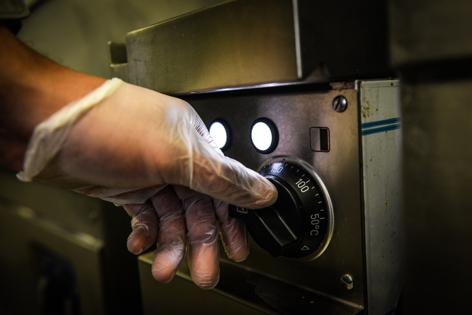 Senior Airman Nathaniel Clark, 786th Force Support Squadron food service journeyman, turns on a stove while preparing dinner at the Rheinland Inn Dining Facility, Ramstein Air Base, Germany, Feb. 4, 2015.  The Rhineland Inn DFAC provides food for more than 1,000 customers a week assigned here or on temporary duty. (U.S. Air Force photo/Senior Airman Nicole Sikorski) 