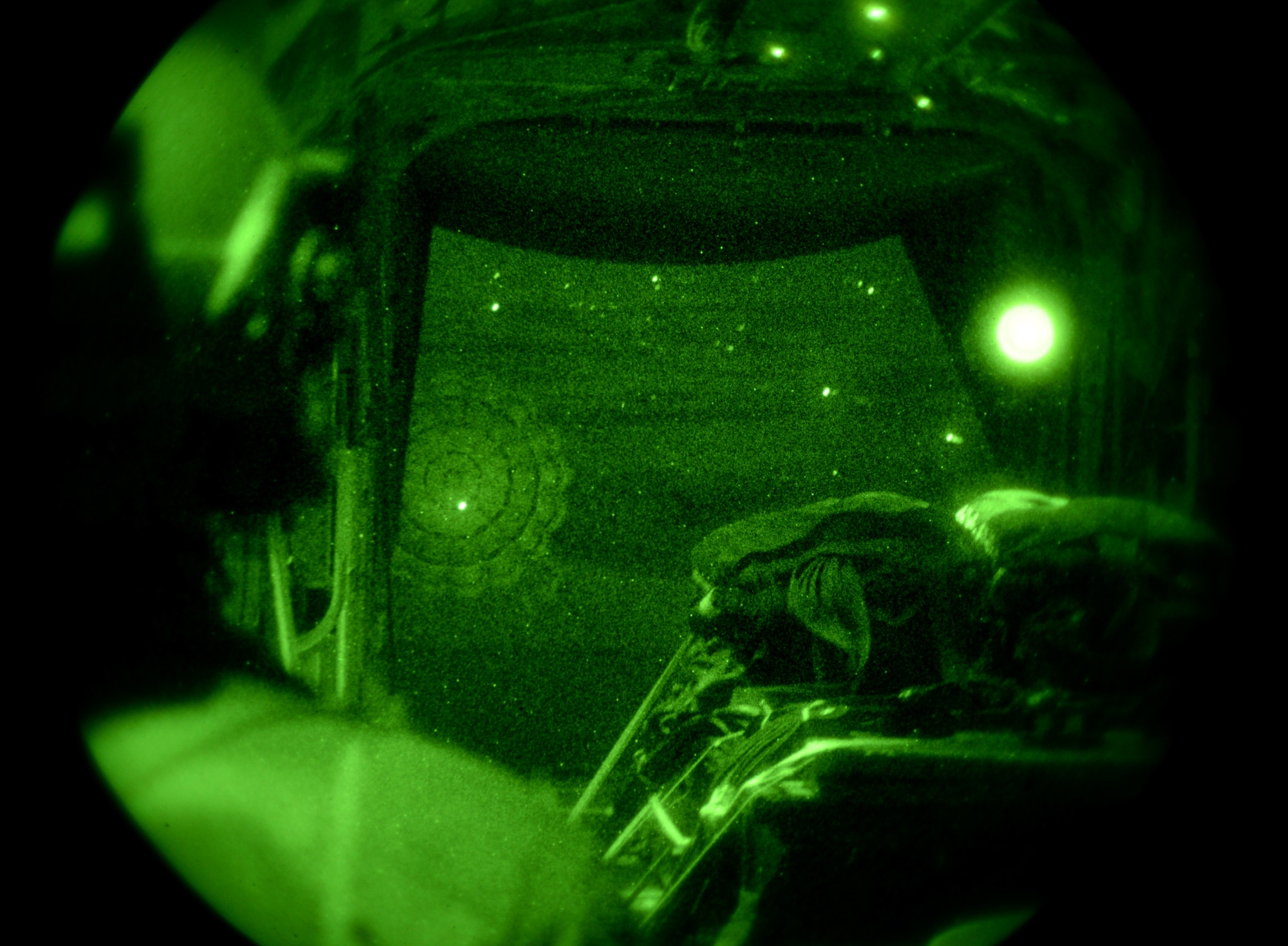 U.S. Air Force Master Sgt. Raymond Beasley, 67th Special Operations Squadron MC-130J Commando II loadmaster from Shalimar Fla., watches heavy equipment exit during airdrop training Jan. 22, 2015, over RAF Sculthorpe, England. Necessary when entering potentially hazardous areas, Air Commandos must hit their target drop zone to resupply special operations forces via airdrop. These require careful planning to ensure even weight distribution and strategic placement of cargo for the quickest, most accurate deployment of supplies. (U.S. Air Force photo by Senior Airman Kate Maurer/Released)