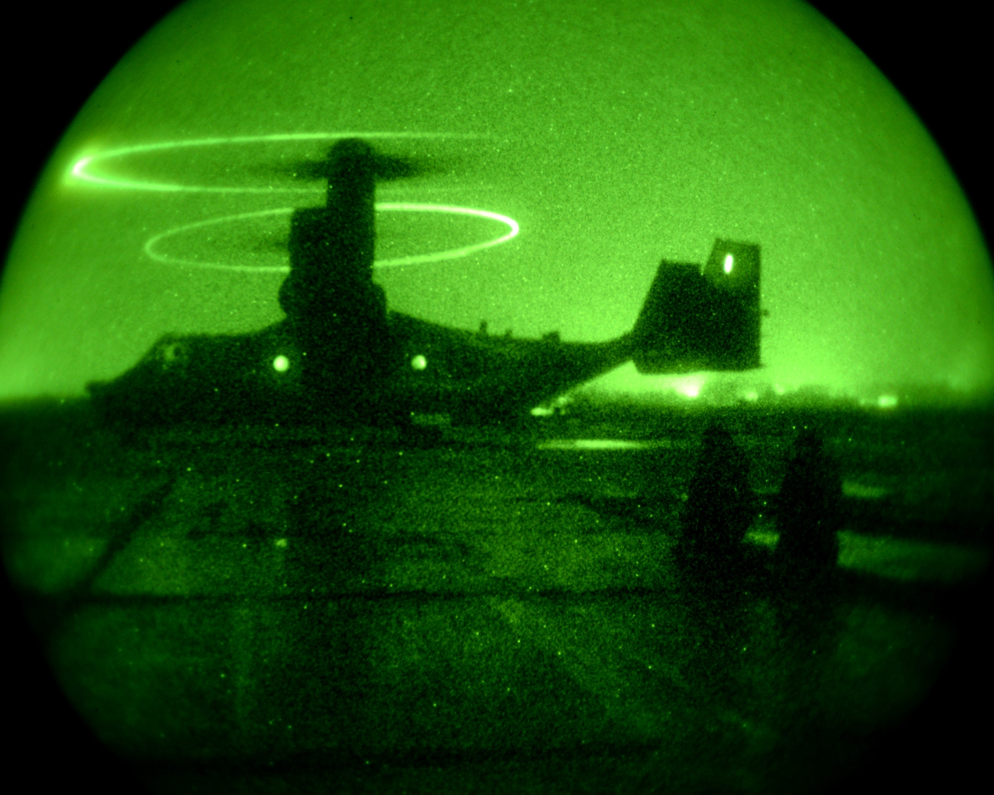 U.S. Air Force Staff Sgt. Mitchell Simpson, left, from Kenton, Tenn., and U.S. Air Force Tech Sgt. Christion House, from Danville, K.Y., both 100th Logistics Readiness Squadron fuels technicians assigned to a Forward Area Refueling Point team, watch a CV-22B Osprey depart after FARP training Jan. 21, 2015, at RAF Sculthorpe. Utilized mostly in potentially hazardous areas, a FARP is the process of refueling aircraft on the ground from another parked aircraft. (U.S. Air Force photo by Senior Airman Kate Maurer/Released)
