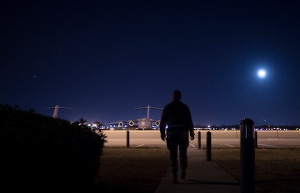 Senior Airman Kathryn Raethel, 437th Operations Support Squadron Airfield Management technician, walks from the Base Operations building out to the flight line to look for any damaged or burnt out runway lights as well as directional signs used by aircraft Feb. 9, 2015, at Joint Base Charleston, S.C. Whenever an in-flight emergency occurs, Base Operations office is notified and begins informing several different agencies to handle the delicate situation. (U.S. Air Force photo/ Senior Airman Dennis Sloan)