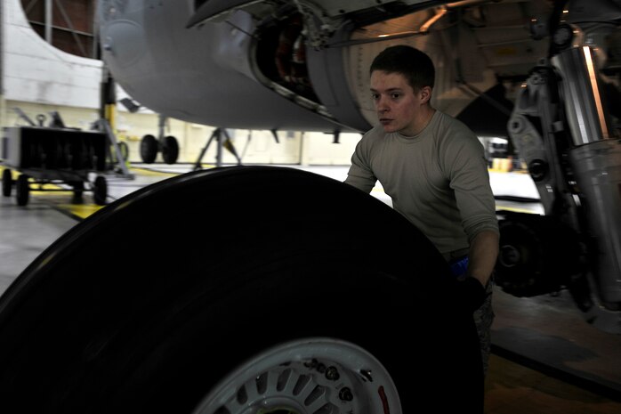 Airman 1st Class Dustin Cannady, a crew chief with the 437th Maintenance Squadron, moves tires for the C-17 Globemaster II during a home station check (HSC) at Joint Base Charleston, S.C., Feb. 9, 2015. The average HSC check is typically three, 24-hour days in which multiple sections of the flight line maintenance squadron perform in-depth inspections of the airframes, looking for damage and deficiency. Cannady and his teammates work late into the night to accomplish the mission. (U.S. Air Force photo/Tech. Sgt. Renae Pittman)