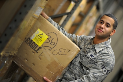 Senior Airman Christopher Ferrand, a material management technician with the 628th Logistics Readiness Squadron, retrieves a fuel quantity computer from supply to fulfill a customer’s needs during night shift at Joint Base Charleston, S.C., Feb. 9, 2015. Ferrand is also a local rapper who performs at events and is recording his own album. (U.S. Air Force photo/Tech. Sgt. Renae Pittman)