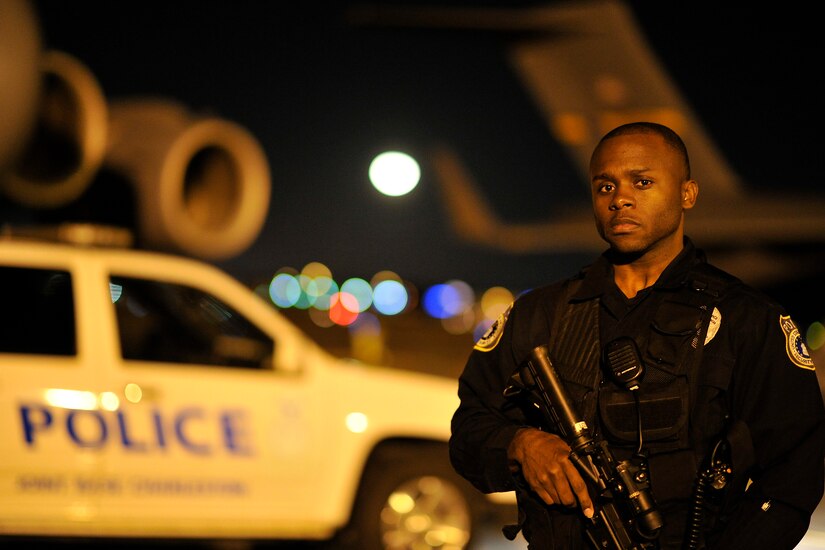 Marvin Walker, a patrolman with the 628th Security Forces Squadron, secures the flightline at Joint Base Charleston, S.C., Feb. 9, 2015. Walker's works through the night to secure entry control points, ensure accountability for all aircraft, and check that there aren't any improperly lit areas on the ramp. (U.S. Air Force photo/Tech. Sgt. Renae Pittman)