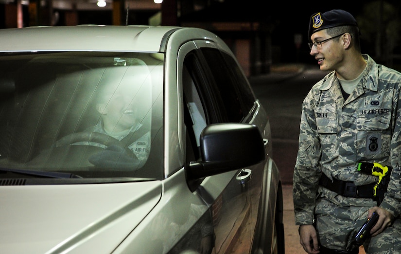 Airman 1st Class Richard Smith, 628th Security Forces Squadron entry controller, talks with visitors as they pass through the Rivers Gate Feb. 8, 2015 on Joint Base Charleston, S.C. Entry controllers are the front line when it comes to base defense and remain vigilant throughout the night to assure the safety of the base’s assets and personnel. (U.S. Air Force photos/Airman 1st Class Clayton Cupit)