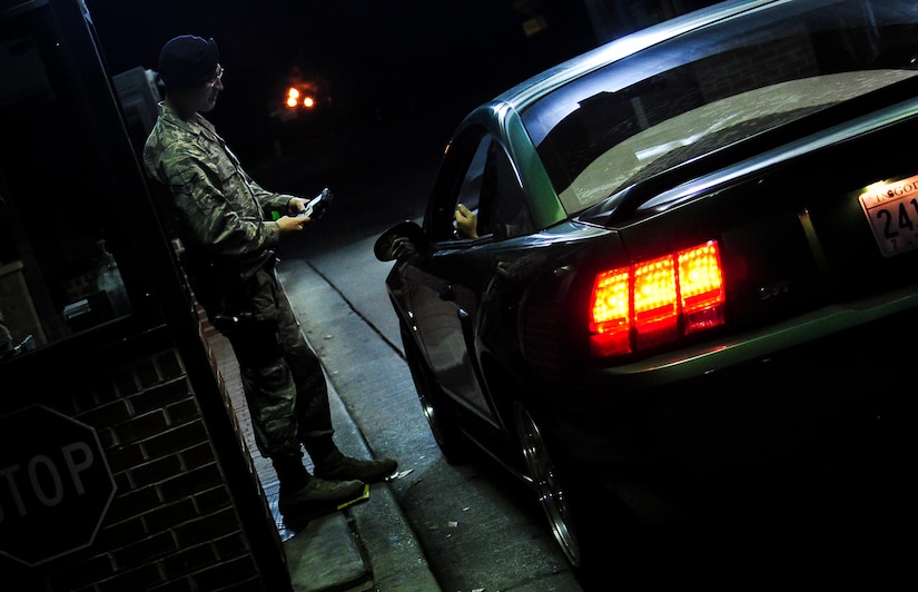 Airman 1st Class Richard Smith, 628th Security Forces Squadron entry controller, checks visitor’s identification as they pass through the Rivers Gate Feb. 8, 2015 on Joint Base Charleston, S.C. Entry controllers are the front line when it comes to base defense and remain vigilant throughout the night to assure the safety of the base’s assets and personnel. (U.S. Air Force photos/Airman 1st Class Clayton Cupit)