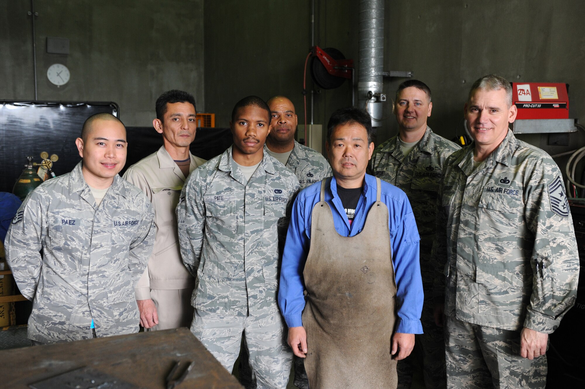 U.S. Air Force Chief Master Sgt. James Laurent, 5th Air Force command chief master sergeant, poses for a photo with members of the 18th Logistics Readiness Squadron maintenance shop on Kadena Air Base, Japan, Feb. 5, 2015. Laurent toured the 18th LRS vehicle maintenance shop and many other squadrons to better educate himself on the importance of Team Kadena. (U.S. Air Force photo by Airman 1st Class Stephen G. Eigel)