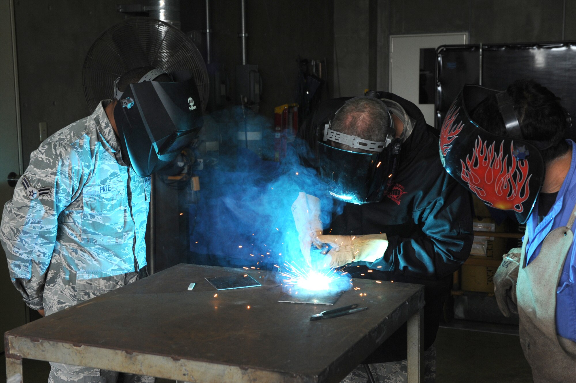 U.S. Air Force Chief Master Sgt. James Laurent, 5th Air Force command chief master sergeant, welds under the supervision of Airman 1st Class Mark Pate, 18th Logistics Readiness Squadron vehicle and vehicular equipment maintenance journeyman, on Kadena Air Base, Japan, Feb. 5, 2015. Laurent was here to visit the different squadrons, mentor Airmen and gain a better understanding of Team Kadena’s mission. (U.S. Air Force photo by Airman 1st Class Stephen G. Eigel)