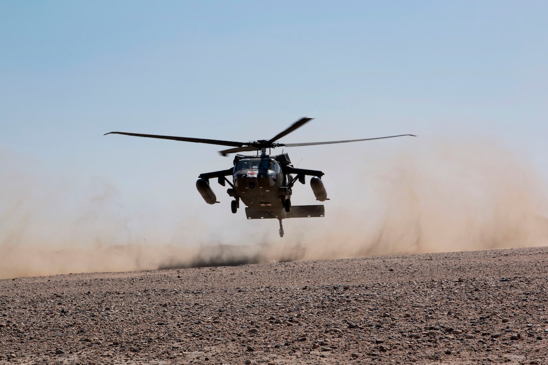 A U.S. UH-60 Black Hawk medevac helicopter performs a dust landing ...