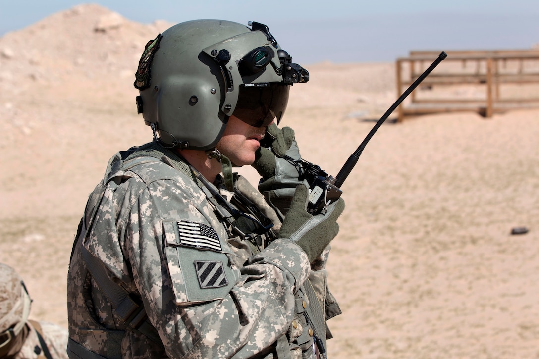 A U.S. soldier uses a radio to talk to a UH-60 Black Hawk medevac helicopter during a casualty evacuation exercise near Camp Buehring, Kuwait, Feb. 5, 2015.