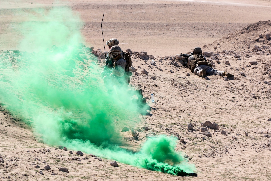 A green smoke grenade is used to signal a UH-60 Black Hawk medevac helicopter during a casualty evacuation exercise near Camp Buehring, Kuwait, Feb. 5, 2015. 