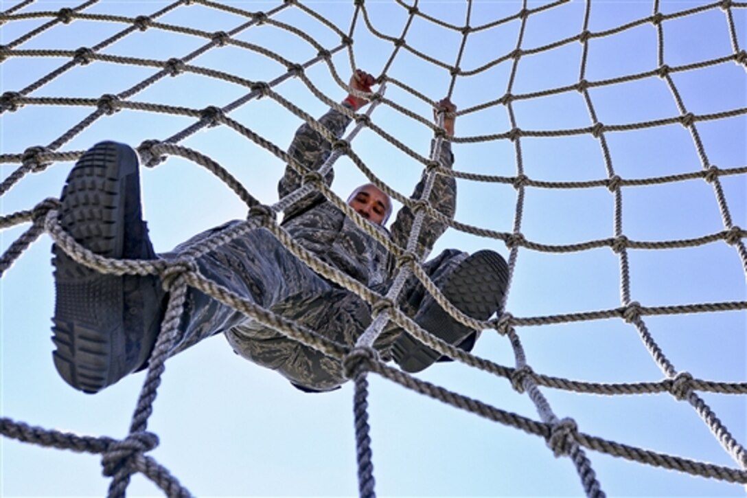 Air Force Master Sgt. Avel Villages attempts to complete an obstacle course during the Texas Military Forces Best Warrior Competition on Camp Swift near Bastrop, Texas, Feb. 6, 2015. Villages is assigned to the 149th Security Forces Squadron.