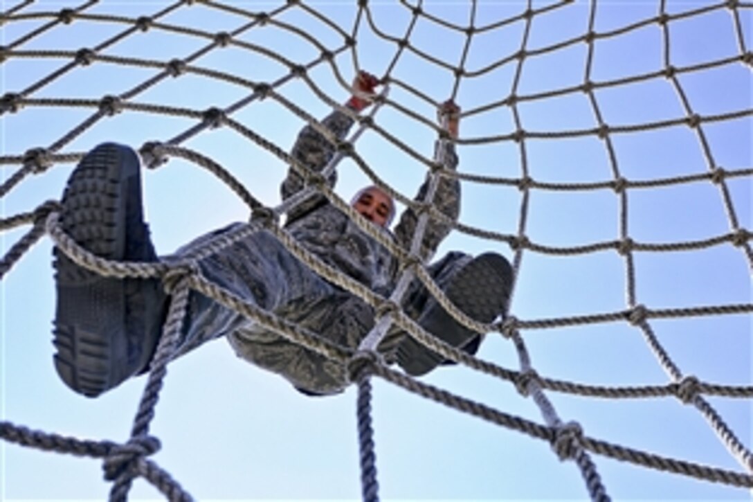 Air Force Master Sgt. Avel Villages attempts to complete an obstacle course during the Texas Military Forces Best Warrior Competition on Camp Swift near Bastrop, Texas, Feb. 6, 2015. Villages is assigned to the 149th Security Forces Squadron.