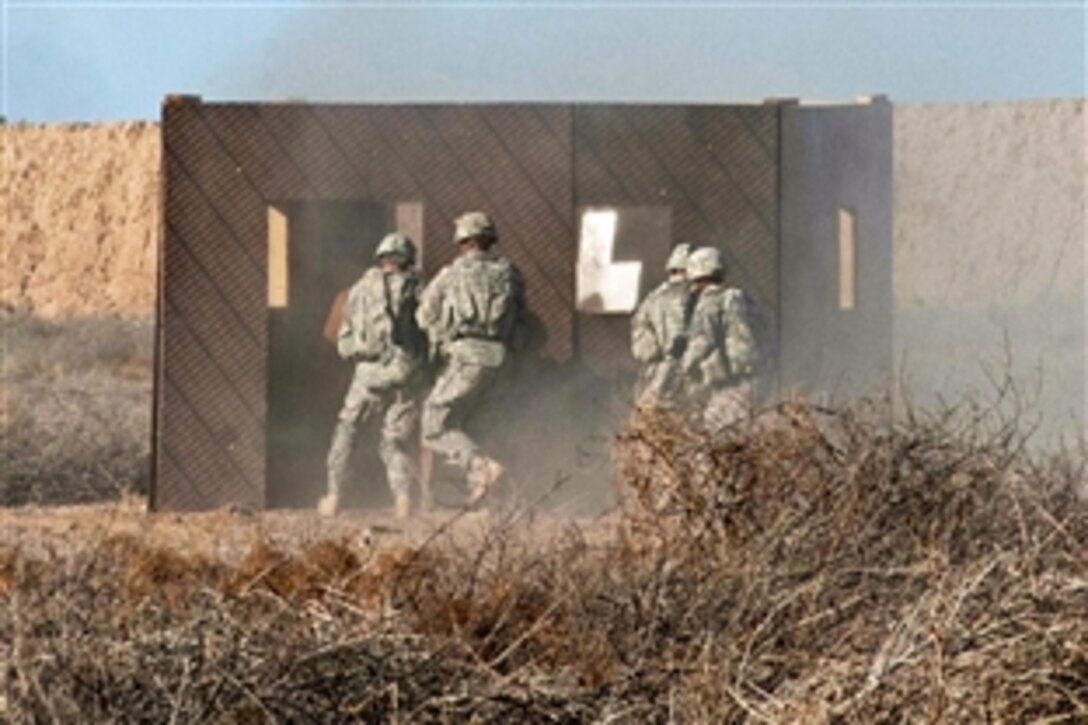 U.S. soldiers rush a building during a platoon live-fire demonstration for Iraqi army trainees and officers on Camp Taji, Iraq, Feb, 5, 2015. In an upcoming session, Iraqis will lead a similar live-fire exercise requiring the use of complex maneuver and communication among units.