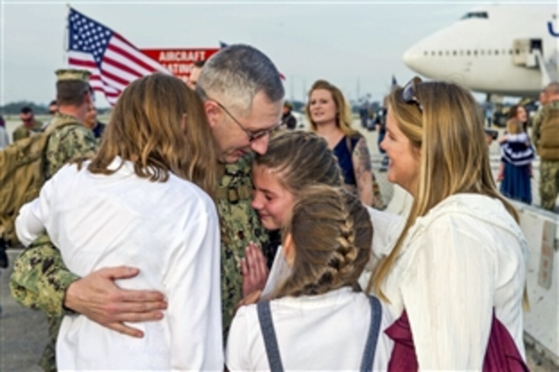 U.S. Navy Lt. Cmdr. Troy Brown greets his family after his return to homeport on Naval Base Ventura County, Calif., Feb. 5, 2015. Brown is a executive officer assigned to Naval Mobile Construction Battalion 4. Seabees from the battalion were deployed to the U.S. Pacific Command area of responsibility. 