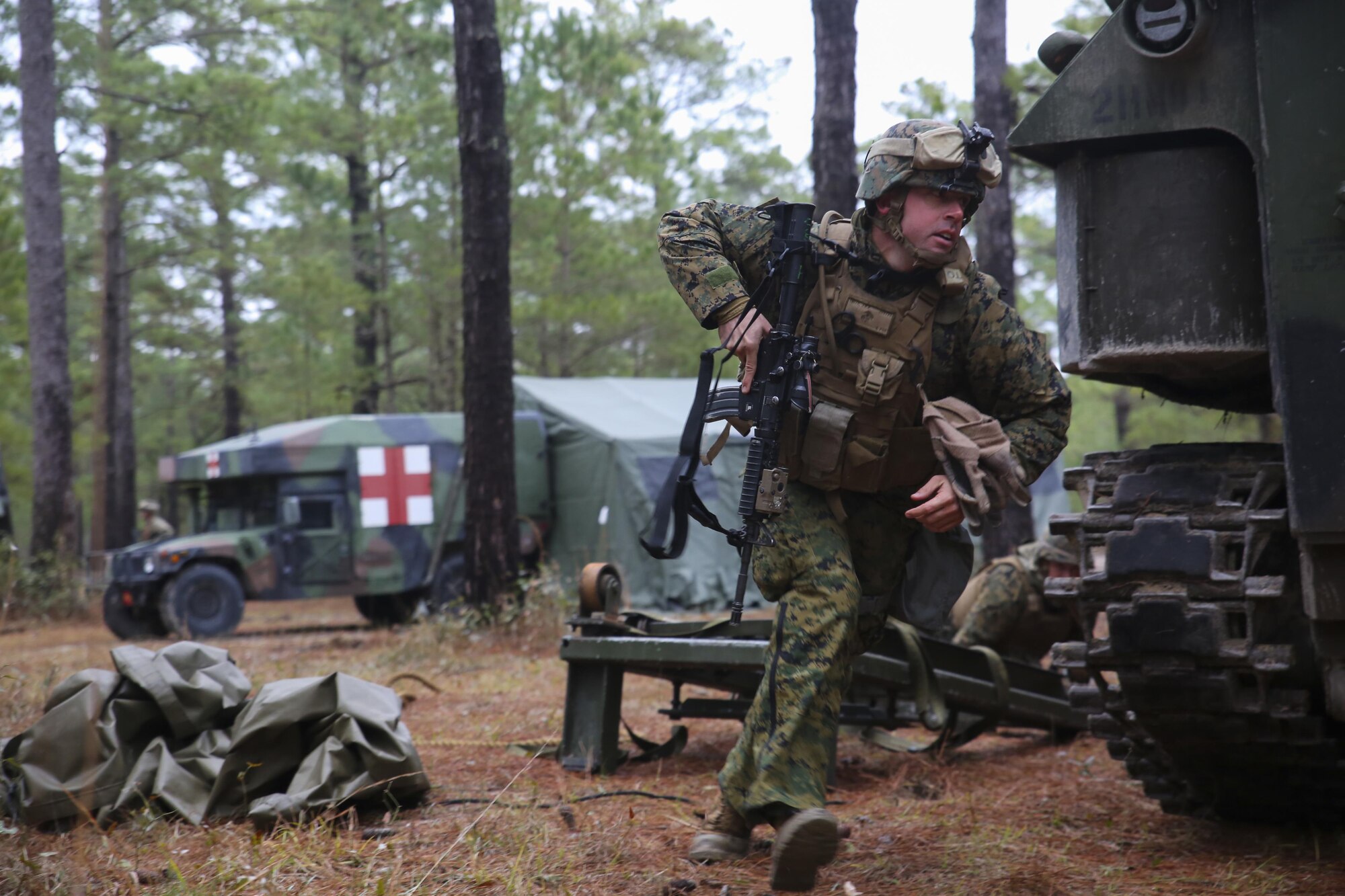 Captain James Smith, an assault amphibious vehicle officer with 2nd Assault Amphibian Battalion, runs for cover during a simulated attack during a week-long field exercise aboard Camp Lejeune, N.C., Jan. 24, 2015. The Battalion faced insurgent role-players during the exercise, which simulated an on-going conflict to maintain combat readiness within the unit.