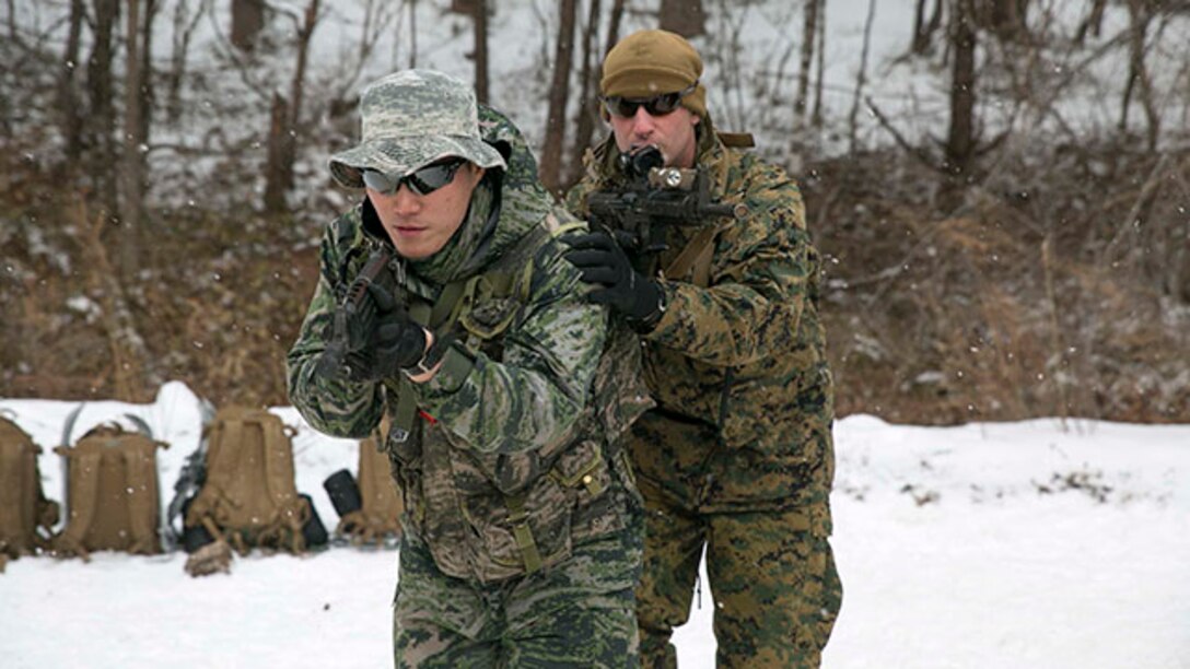 Republic of Korea Marine Staff Sgt. Park Hyunsik, left, trains for military operations in urban terrain alongside U.S. Marine Sgt. Patrick J. Paul during Korean Marine Exchange Program 15-4 Feb. 5 at the Pyeongchang Winter Training Facility, Pyeongchang, Republic of Korea. Sharing cultures is a significant factor in gaining a better understanding of the combat tactics of the two forces despite the language barrier, according to ROK Marine Capt. Moon Jung Hwan. KMEP 15-4 is just one iteration in a series of continuous bilateral training exercises designed to enhance the ROK and U.S. alliance, promote stability on the Korean Peninsula and strengthen ROK and U.S. military capabilities and interoperability. Park, from Inchon, ROK, is a reconnaissance man with 1st Reconnaissance Battalion, 1st ROK Marine Division. Paul, from Manchester, New Hampshire, is a rifleman with Company L, 3rd Battalion, 3rd Marine Regiment, currently assigned to 4th Marine Regiment, 3rd Marine Division, III Marine Expeditionary Force under the unit deployment program. (U.S. Marine Corps photo by Pfc. Cedric R. Haller II/Released)