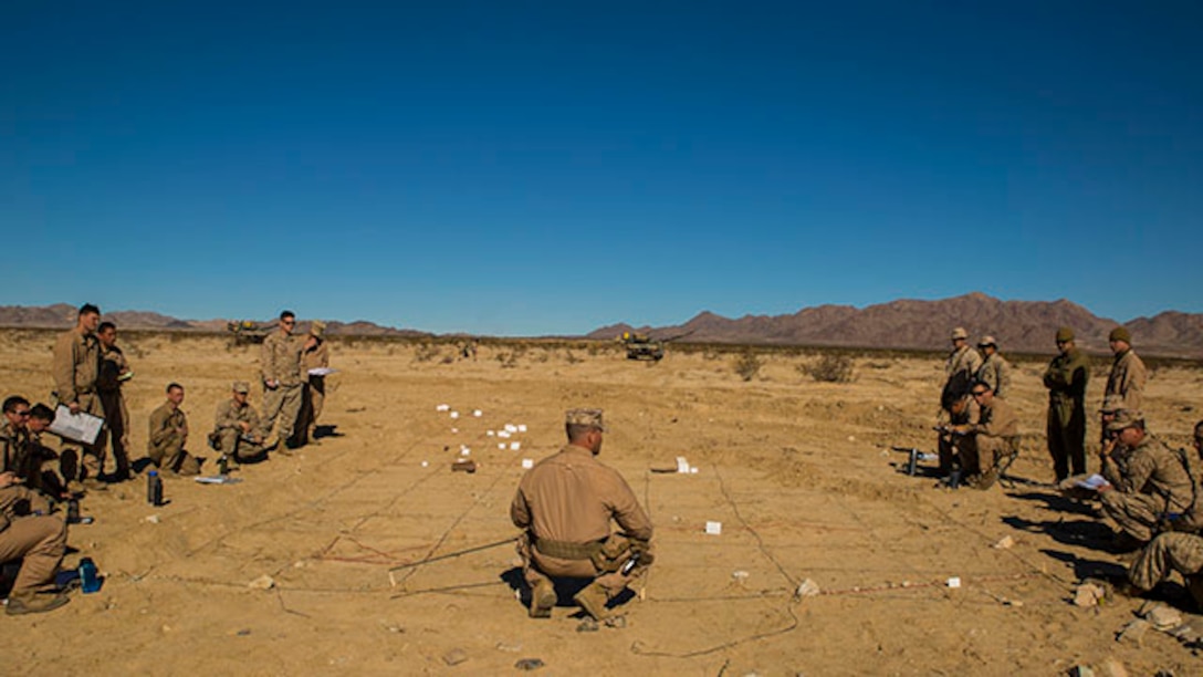Capt. Paul B. Kozick briefs Marines from Company D Feb. 1  on the plan for the Tank Mechanized Assault Course at Marine Air Ground Combat Center Twentynine Palms as part of Integrated Training Exercise 2-15. The TMAC is a training event used to bring multiple elements of the Marine Air-Ground Task Force together in one event. Kozick, a Dillsburg, Pennsylvania, native, is tank officer and the company commander for Company D, 1st Tank Battalion, 1st Marine Division, I Marine Expeditionary Force. The Marines are also with Company D. (U.S. Marine Corps photo by Lance Cpl. William Hester)