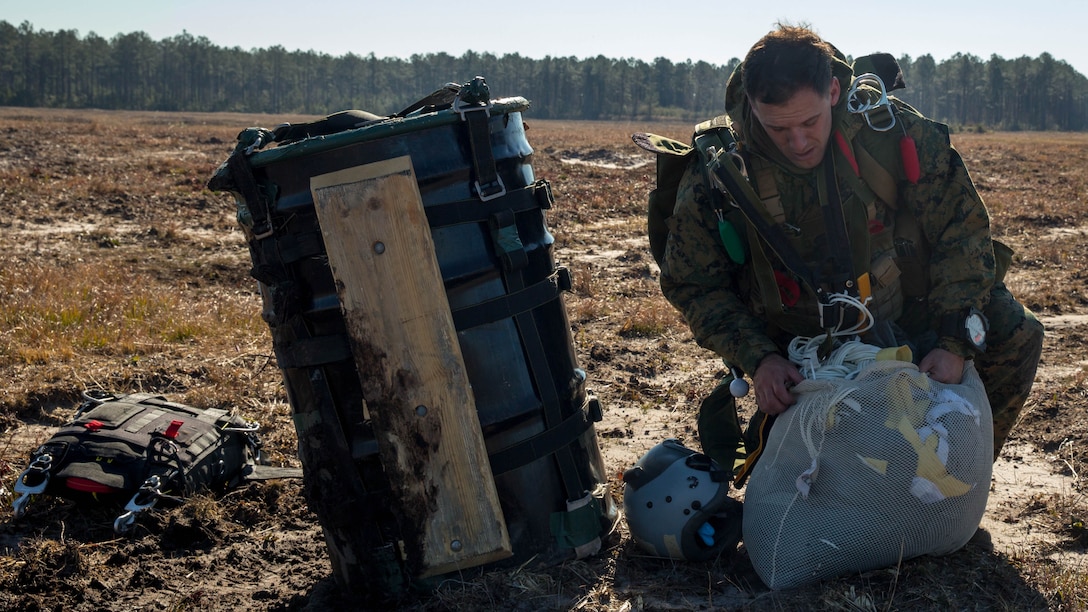 A Marine, with Force Company, 2nd Reconnaissance Battalion, 2nd Marine Division, packs his parachute after completing a High Altitude Low Opening free-fall jump during a parachute training exercise at Training Landing Zone Pheasant aboard Camp Lejeune, N.C., Jan. 28. When Marines with the battalion insert for a mission, they carry enough equipment to sustain themselves for up to 96 hours.