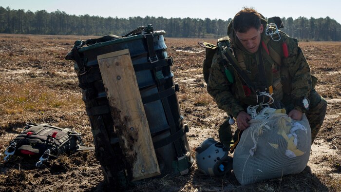 A Marine, with Force Company, 2nd Reconnaissance Battalion, 2nd Marine Division, packs his parachute after completing a High Altitude Low Opening free-fall jump during a parachute training exercise at Training Landing Zone Pheasant aboard Camp Lejeune, N.C., Jan. 28. When Marines with the battalion insert for a mission, they carry enough equipment to sustain themselves for up to 96 hours.