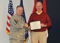 During the Jan. 23 Town Hall, Huntsville Center Commander Col. Robert J. Ruch presents Mark Batchelor with a Certificate of Achievement on behalf of Brig. Gen. Jeffrey Clark, Director of the Walter Reed National Military Medical Center.
