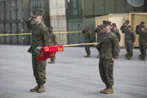 Capt. Keaton J. Thomas, Commanding Officer of Marine Air Ground Task Force Materiel Distribution Company, presents his command during the company’s activation ceremony, Feb. 9, 2015, aboard Camp Lejeune, North Carolina. The company has been created within 2nd Supply Battalion, Combat Logistics Regiment 25, 2nd Marine Logistics Group, to establish a proof of principle on the reorganization of intermediate supply and distribution capabilities in order to provide tailored capabilities to units deploying in support of II Marine Expeditionary Force. This new company will be comprised of some preexisting platoons from Supply Company, as well as a motor transportation capability from the Headquarters and Support Company and an additional 30 Marines to form Distribution Liaison Cells. (U.S. Marine Corps photo by Cpl. Elizabeth A. Case/Released)