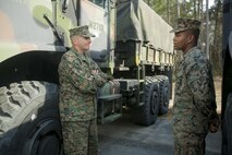 Brig. Gen. Charles G. Chiarotti, left, Commanding General, 2nd Marine Logistics Group, speaks with Cpl. David A. Fowler, a motor vehicle operator with Marine Air Ground Task Force Materiel Distribution Company, following the company’s activation ceremony, Feb. 9, 2015, aboard Camp Lejeune, North Carolina. Fowler and other Marines with the company discussed the unit’s capabilities with Chiarotti. The company has been created within 2nd Supply Battalion, Combat Logistics Regiment 25, 2nd Marine Logistics Group, to establish a proof of principle on the reorganization of intermediate supply and distribution capabilities in order to provide tailored capabilities to units deploying in support if the II Marine Expeditionary Force. The integration of personnel in the new company will enhance the unit’s ability to support outside units, with no changes to garrison support operations or deployed support operations. (U.S. Marine Corps photo by Cpl. Elizabeth A. Case/Released)