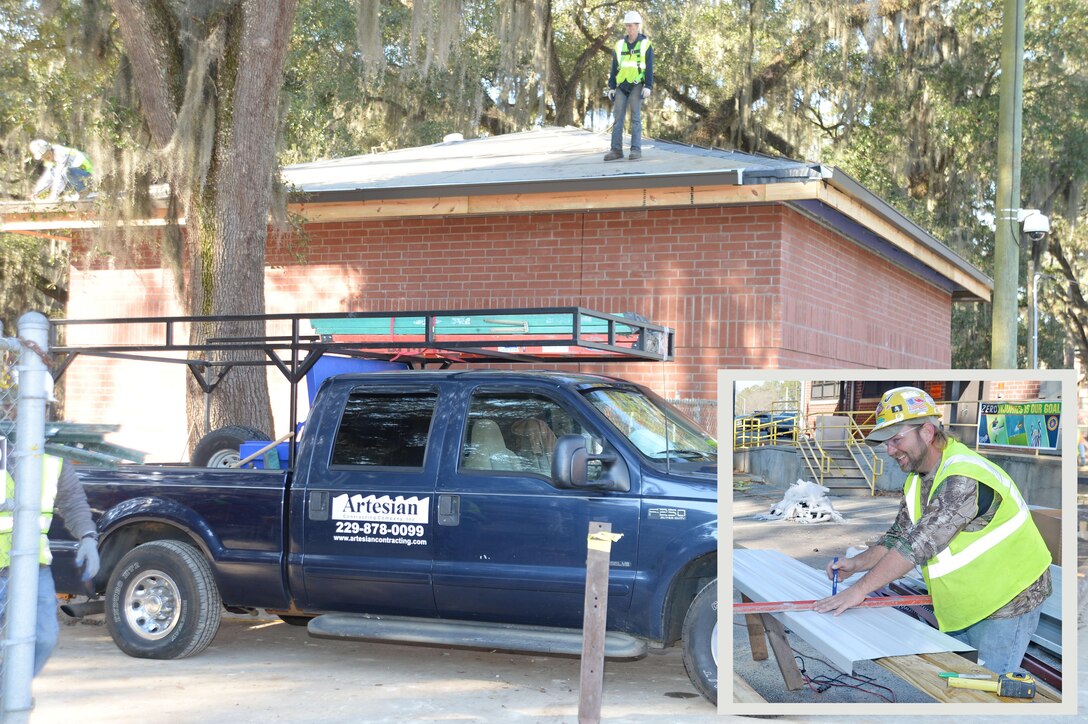Contractors aboard Marine Corps Logistics Base Albany work to install roofing on the installation’s new consolidated emergency response system construction project, recently. Construction worker, Clinton Janes, 3D Construction, Artesian Contracting Company Inc., Albany, Ga., (right) measures and cuts sheets of metal roofing for the new CERS facility. The CERS is a communication system, which will be used by the base’s first responders in the event of an emergency or crisis.