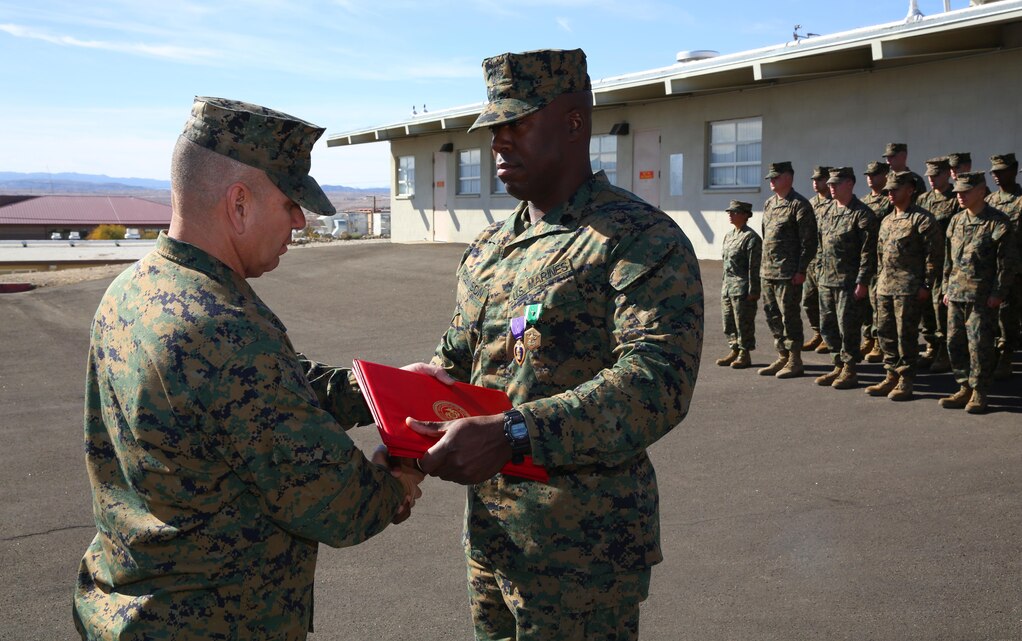 1st Sgt. Frank Robinson, Company A First Sergeant, Headquarters Battalion, shakes the hand of Lt. Col. Dennis Sanchez, HQBN Commanding Officer, aboard the Combat Center, after being pinned with a Purple Heart and a Navy and Marine Corps Commendation Medal, Jan. 22, 2015. Marines from HQBN congratulated Robinson after the citation and awards were given. (Official Marine Corps photo by Lance Cpl. Thomas Mudd/Released)