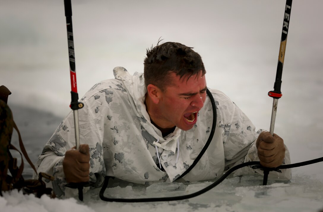 Staff Sgt. John Freeseha, instructor, Animal Packers Course, begins singing the Marine’s Hymn after completing a plunge into freezing water during an Ice-Breaker Drill as part of Winter Mountain Leaders Course 1-15 at Levitt Lake, Marine Corps Mountain Warfare Training Center, Bridgeport, Calif., Jan. 30, 2015. It was the first time in approximately three years since the drill was conducted at MCMWTC. (Official Marine Corps photo by Cpl. Charles Santamaria/Released)