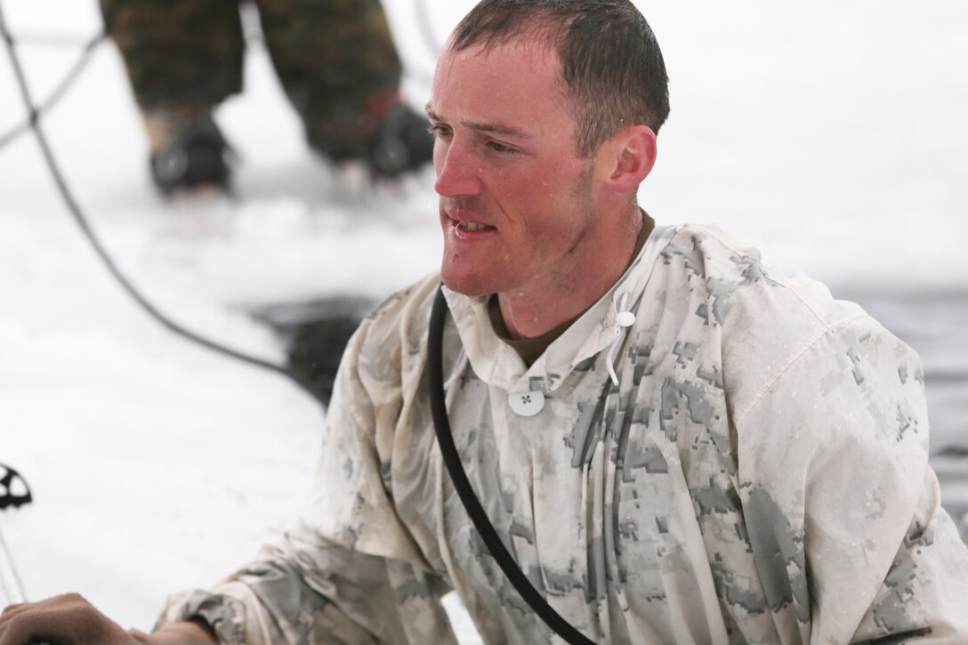 Sgt. Sloan Seiler, Winter Mountain Leaders Course 1-15, student, Marine Corps Mountain Warfare Training Center, requests permission to exit the freezing water during an Ice-Breaker Drill as part of WMLC 1-15 at Levitt Lake, MCMWTC, Bridgeport, Calif., Jan. 30, 2015. Each Marine slid into the water on the skis with the five gallon weighted pack and a pair of ski poles. Their objective was to get the pack out of the water and then swim to the edge where they would be tested on their mental endurance while under the strain of the freezing temperature of the water. (Official Marine Corps photo by Lance Cpl. Medina Ayala-Lo/Released)