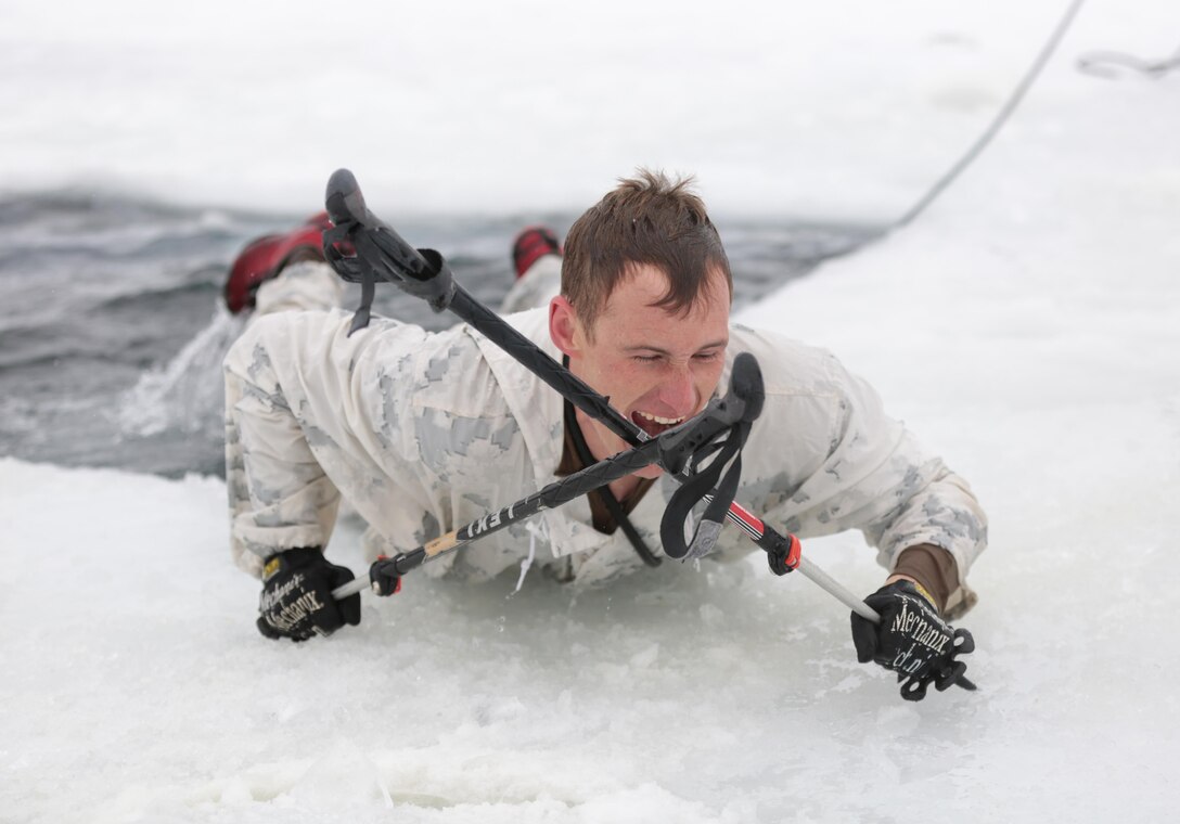 Chief Petty Officer John K. Maury, senior enlisted officer, Mountain Medicine Program, Marine Corps Mountain Warfare Training Center, native of Macauley Hill, Calif., uses his ski poles to exit the freezing water during an Ice-Breaker Drill at Levitt Lake, MCMWTC, Bridgeport, Calif., Jan. 30, 2015. The six week course, which began Jan. 5 and is scheduled to end Feb. 18., is designed to train Marines on what to expect in a cold weather environment. (Official Marine Corps photo by Lance Cpl. Medina Ayala-Lo/Released)