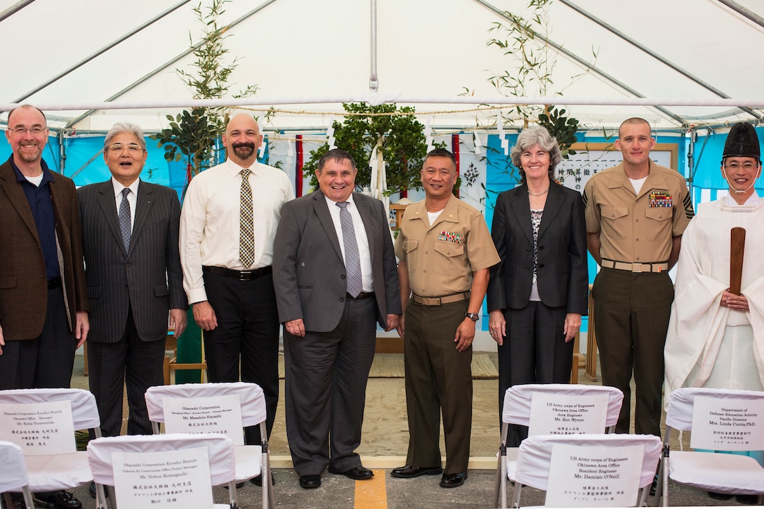 From left to right, members of the Department of Defense Education Activity; U.S. Marine Corps Major Allen Agra, executive officer of Headquarters and Support Battalion; Dr. Linda Curtis, pacific director, Department of Defense Education Activity; U.S. Marine Corps 1st Sgt. Marcus D. Reese, first sergeant of Bravo Company, Headquarters and Support Battalion; and Master of Ceremony, a Naminoue Shrine Priest pose for a picture in front of the altar following a ground blessing ceremony at Zukeran Elementary School Grounds, Camp Foster, Okinawa, Japan, Jan. 15, 2015. The ceremonial blessing was performed for the safety and completion of the demolition of 45 military housing units and the construction of a new school.  (U.S. Marine Corps photo by MCIPAC Combat Camera Pfc. Makenzie Fallon/ Released)  