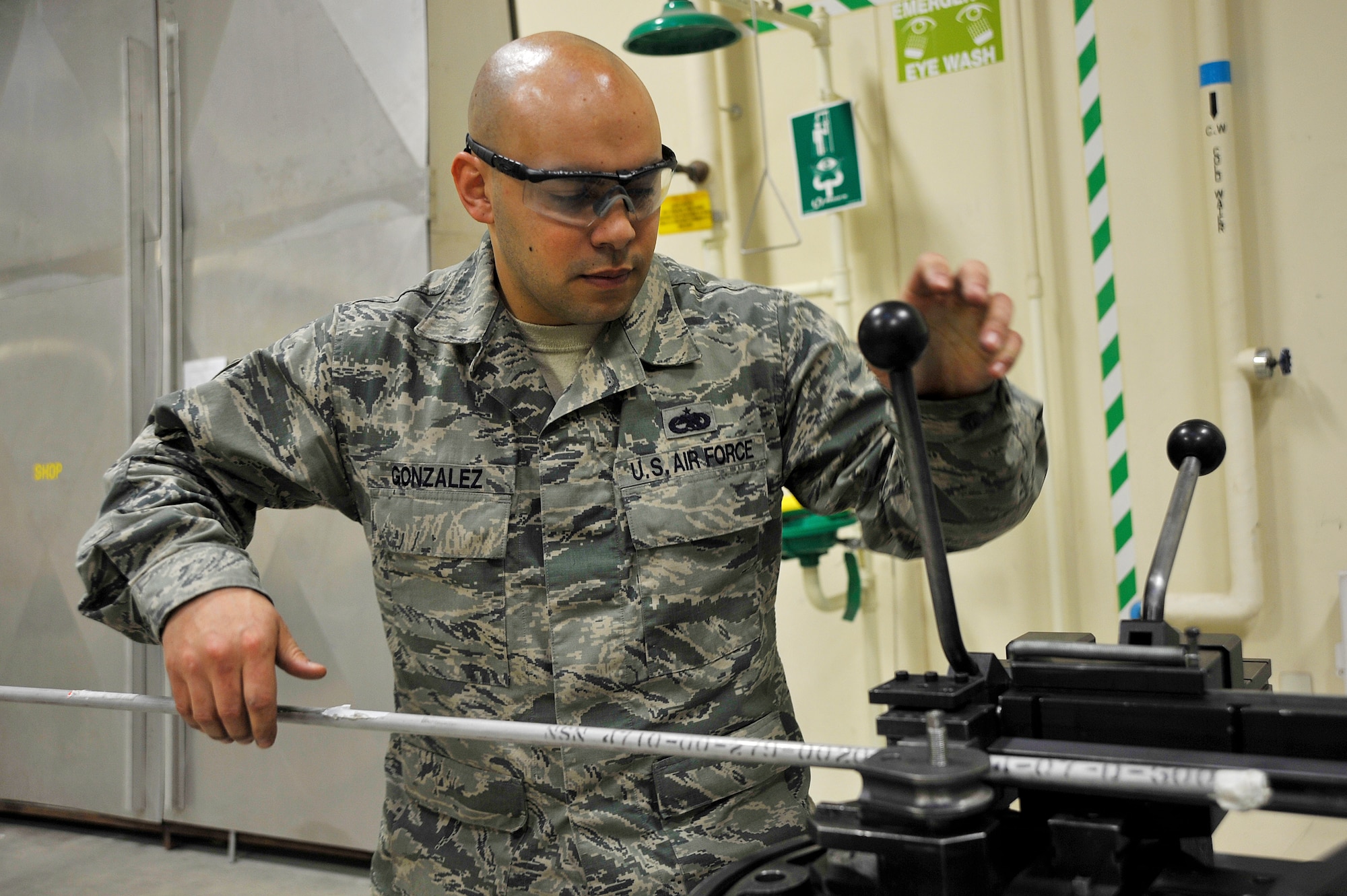 U.S. Air Force Staff Sgt. Thomas Gonzalez, 35th Maintenance Squadron aircraft structural maintenance craftsman, places tubing on a production tube bender at Misawa Air Base, Japan, Feb. 10, 2015. In addition to structural sheet metal repairs, the aircraft structural maintenance team modifies tubing parts for the F-16 Fighting Falcon. (U.S. Air Force photo by Senior Airman Jose L. Hernandez-Domitilo)