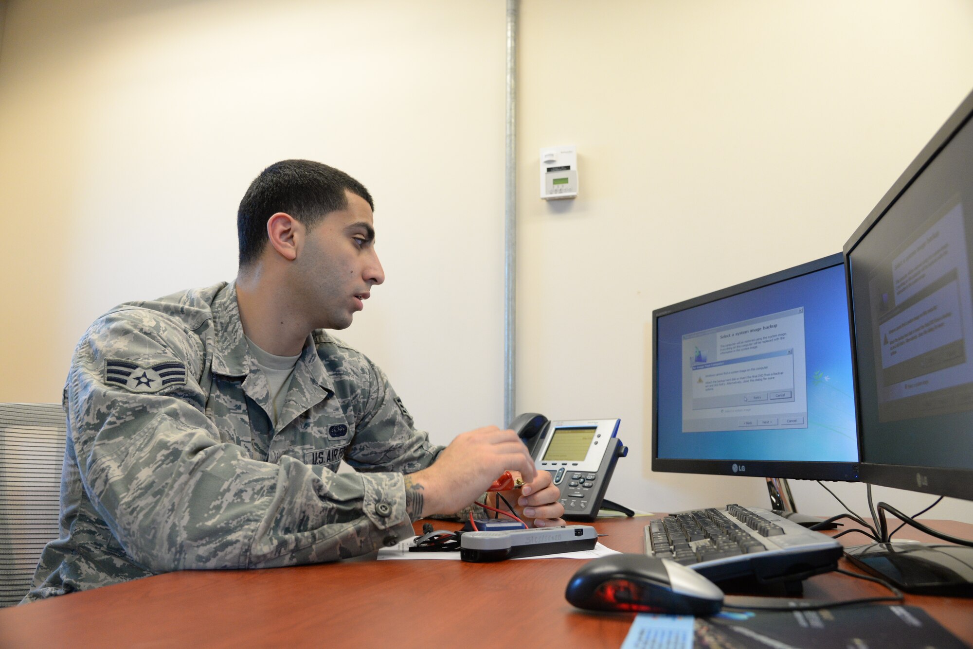 Senior Airman Tarek Salem, a 51st Communications Squadron client systems technician, trouble shoots a hard drive failure Feb. 6, 2015, at Osan Air Base, Republic of Korea. The client systems technicians provide support so everyone else is able to do their job. (U.S. Air Force photo by Senior Airman Matthew Lancaster)