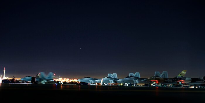 An F-22 Raptor assigned to the 94th Fighter Squadron, Joint Base Langley-Eustis, Va., taxis toward the runway prior to flying a Red Flag 15-1 training mission at Nellis Air Force Base, Nev., Feb. 4, 2015. Night missions have been integrated into Red Flag to prepare aircrews for missions in low-light environments. (U.S. Air Force photo by Airman 1st Class Mikaley Towle)