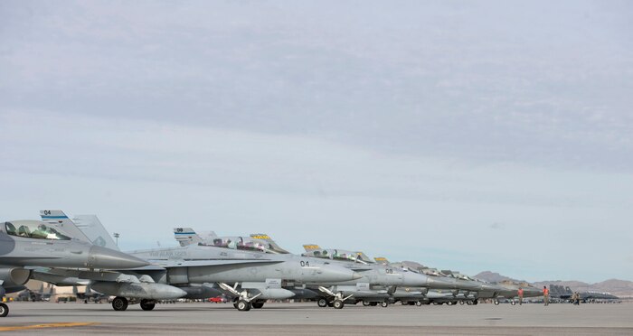 Numerous aircraft participating in Red Flag 15-1 wait for their turn to take off for training exercises at Nellis Air Force Base, Nev., Jan. 28, 2015. All four branches of the U.S. military and air forces from allied nations participate in Red Flag. The training is conducted to familiarize forces for future operations. (U.S. Air Force photo by Airman 1st Class Mikaley Towle)