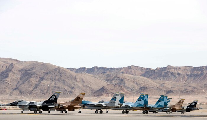 Five F-16 Fighting Falcons and three F-15 Eagles assigned to the 64th Aggressor Squadron wait at the end-of-runway for their turn to take off at Nellis Air Force Base, Nev., Jan. 28, 2015. The 64th AGRS’ mission is to prepare combat air forces for potential conflicts or war with challenging and realistic threat replication, training, academics and feedback.  (U.S. Air Force photo by Airman 1st Class Mikaley Towle)